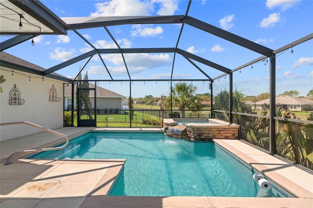 view of swimming pool with glass enclosure, a patio, and a pool with connected hot tub