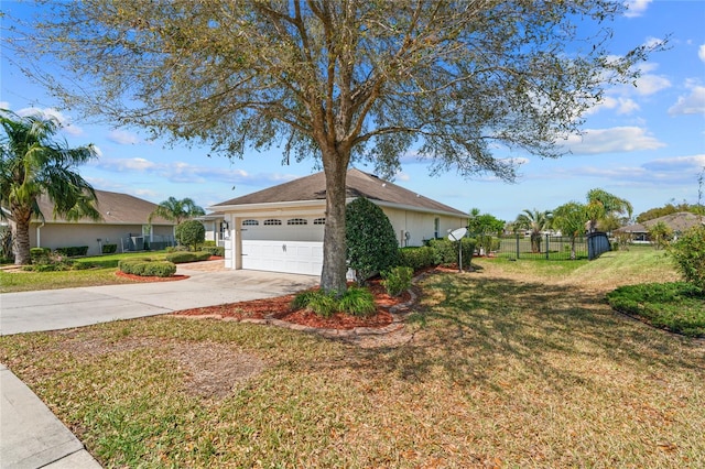 view of side of property with an attached garage, fence, a yard, and driveway