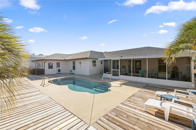 pool featuring a patio and a sunroom