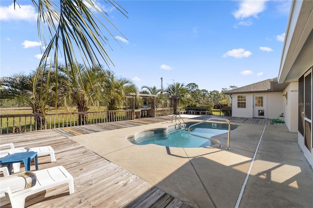 view of swimming pool with a deck