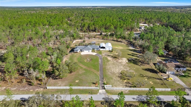 birds eye view of property with a wooded view