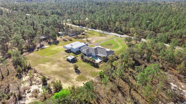 drone / aerial view featuring a wooded view