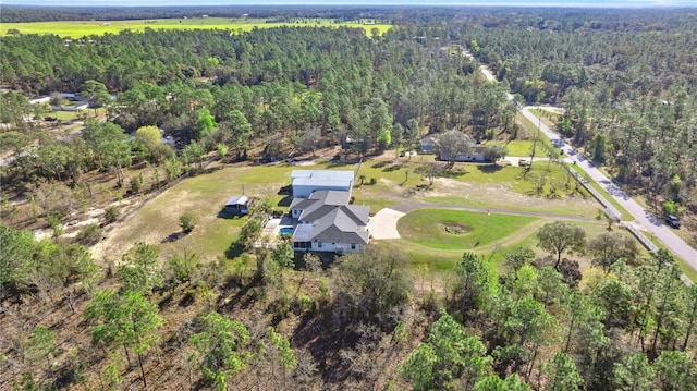 drone / aerial view featuring a forest view