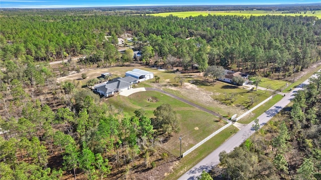 drone / aerial view featuring a forest view