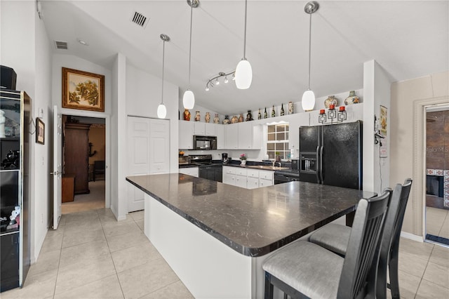 kitchen with light tile patterned floors, visible vents, and black appliances