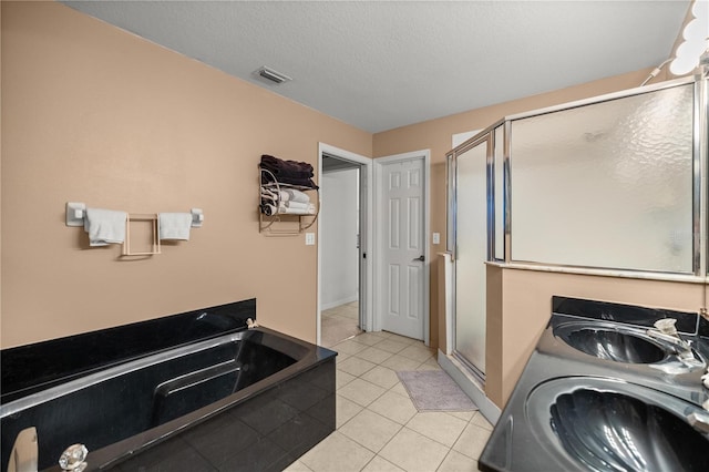 full bathroom with tile patterned floors, visible vents, a stall shower, a sink, and a bath