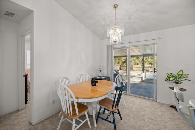 dining area with vaulted ceiling, a notable chandelier, baseboards, and carpet floors