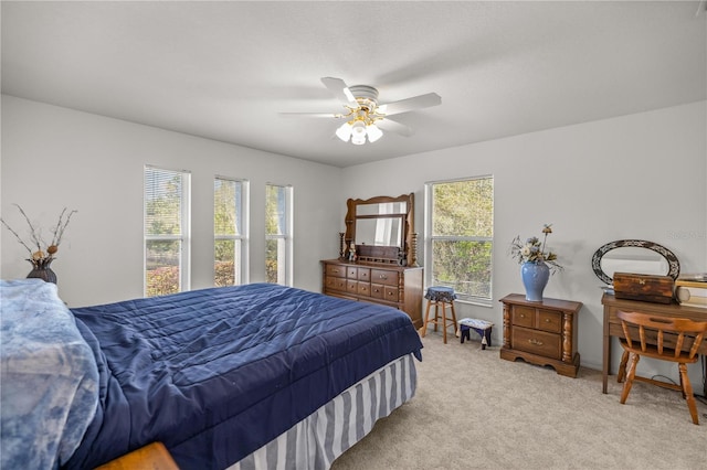 carpeted bedroom with baseboards and ceiling fan