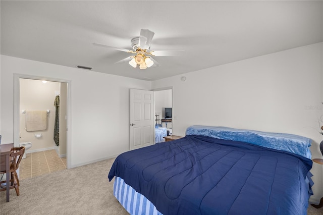 bedroom with visible vents, connected bathroom, baseboards, ceiling fan, and light colored carpet