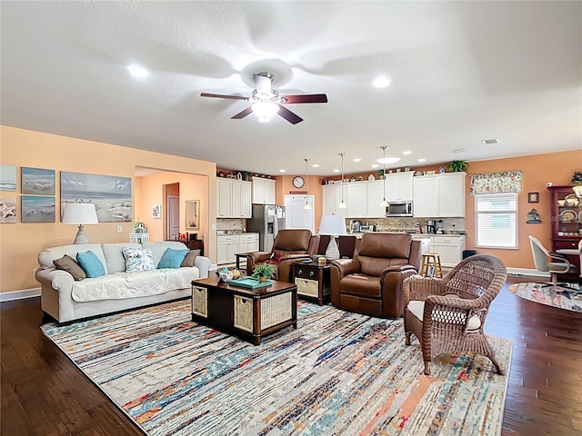 living area featuring dark wood finished floors, recessed lighting, baseboards, and a ceiling fan