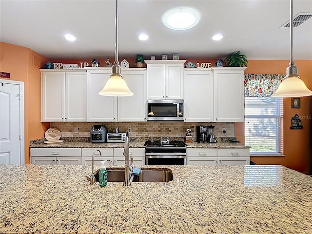 kitchen featuring white cabinetry, tasteful backsplash, visible vents, and appliances with stainless steel finishes