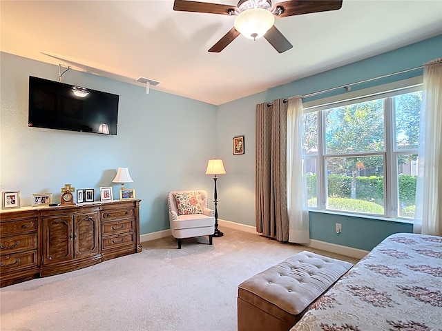 carpeted bedroom featuring visible vents, a ceiling fan, and baseboards