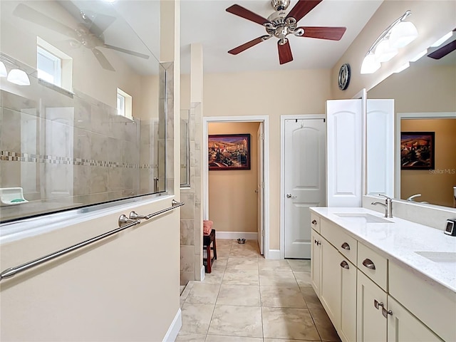 full bath with a sink, ceiling fan, double vanity, and a walk in shower