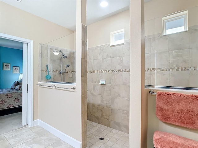 ensuite bathroom with a walk in shower, baseboards, and ensuite bathroom