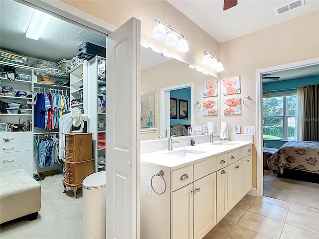 ensuite bathroom featuring a sink, visible vents, double vanity, and ensuite bathroom