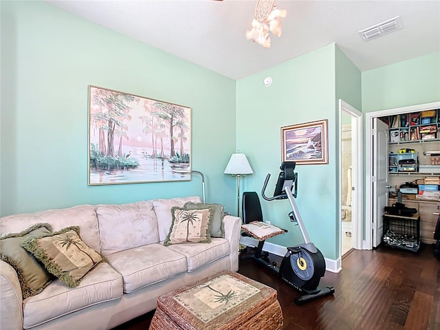 living area with dark wood finished floors, baseboards, and visible vents