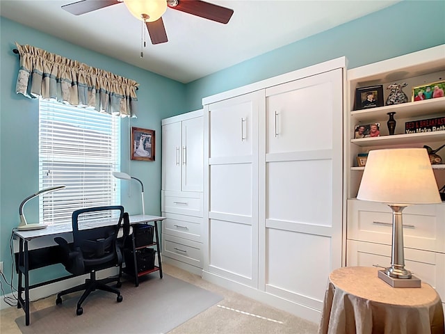 home office with light carpet and ceiling fan