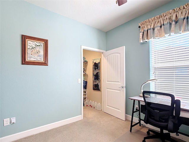 home office featuring baseboards and light colored carpet