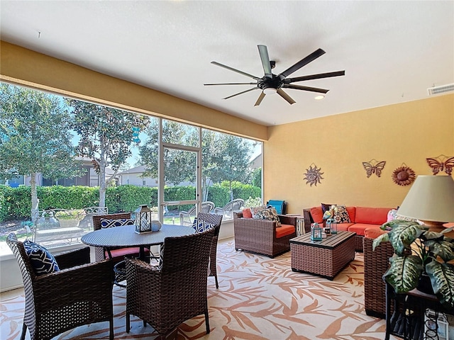 sunroom / solarium featuring a ceiling fan and visible vents