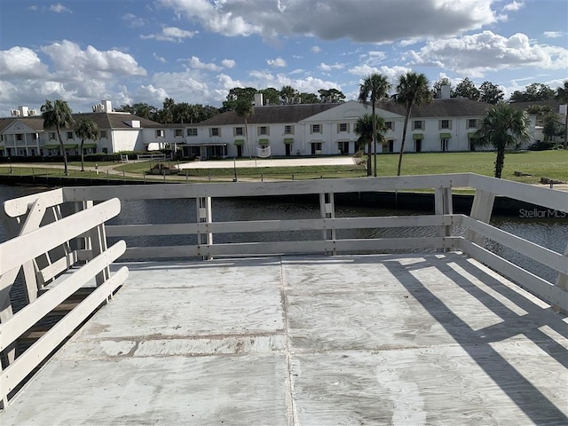 view of patio with a residential view and a water view