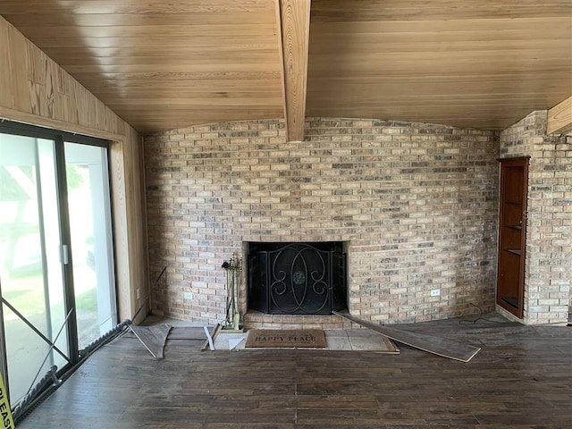 unfurnished living room featuring brick wall, a brick fireplace, vaulted ceiling with beams, wood ceiling, and wood finished floors