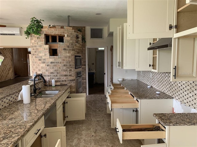 kitchen with oven, visible vents, a sink, tasteful backsplash, and extractor fan