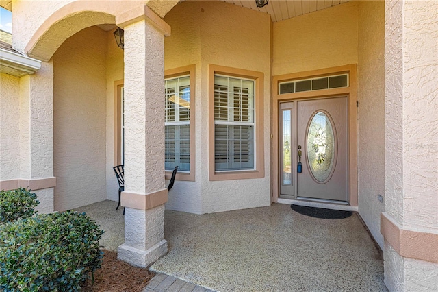 entrance to property with stucco siding