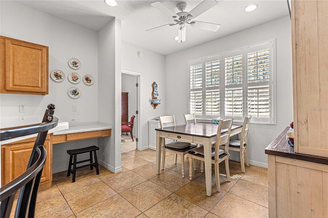 dining area featuring light tile patterned floors, baseboards, and ceiling fan