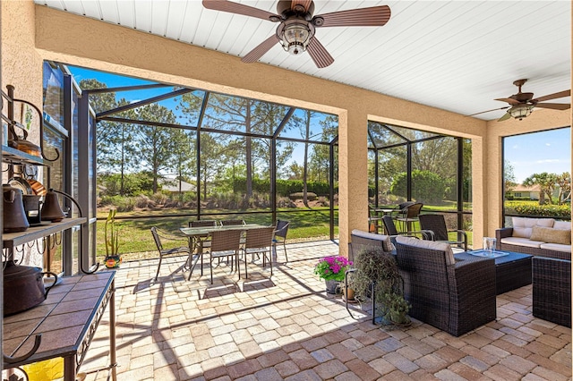 sunroom / solarium featuring ceiling fan