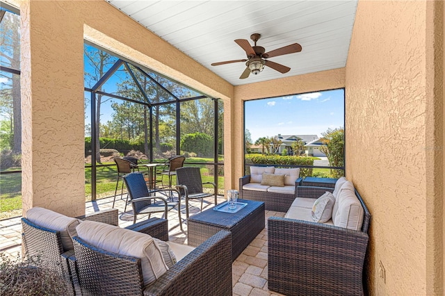 view of patio featuring an outdoor hangout area, a lanai, and a ceiling fan