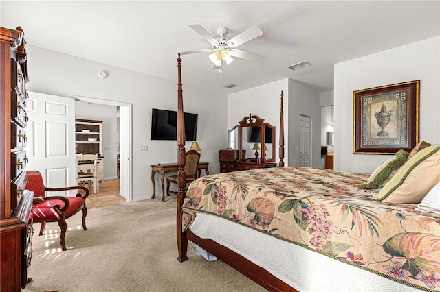 bedroom featuring visible vents, baseboards, light colored carpet, and ceiling fan