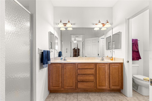 full bathroom with toilet, a stall shower, a ceiling fan, a sink, and double vanity