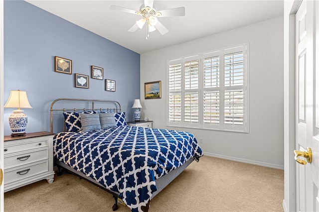 carpeted bedroom with a ceiling fan and baseboards