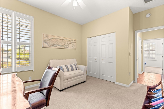 carpeted office space with plenty of natural light, baseboards, and a ceiling fan