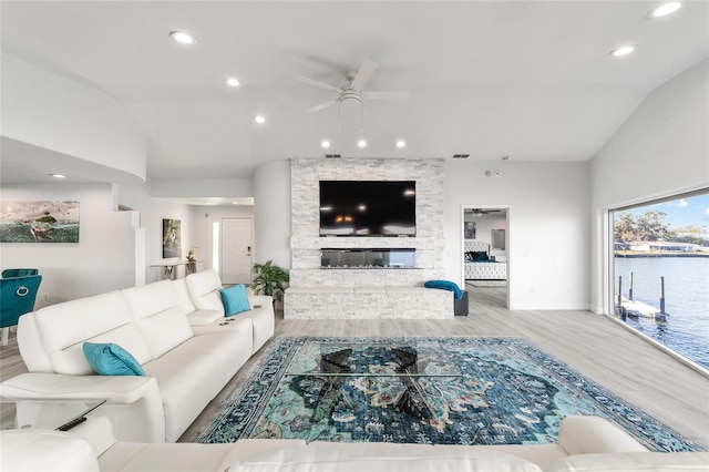 living area with wood finished floors, lofted ceiling, ceiling fan, and recessed lighting