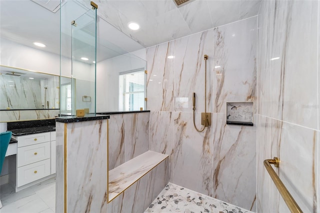 bathroom featuring recessed lighting, a marble finish shower, marble finish floor, and vanity