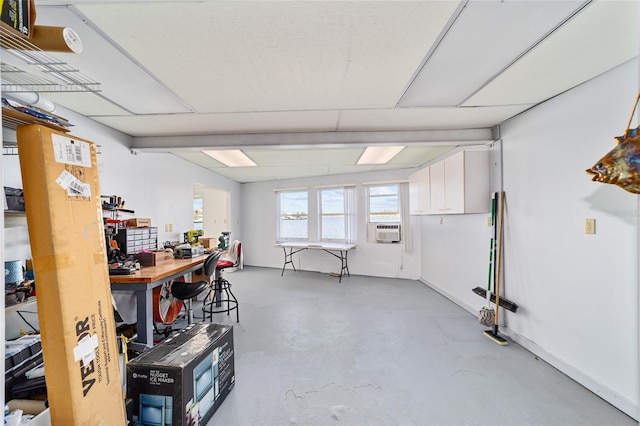 basement featuring a workshop area, cooling unit, and baseboards