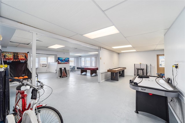 game room featuring a drop ceiling, pool table, and concrete flooring