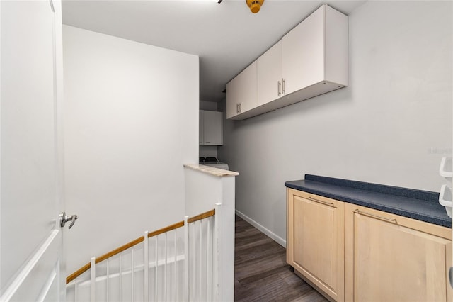 interior space featuring baseboards and dark wood-style floors