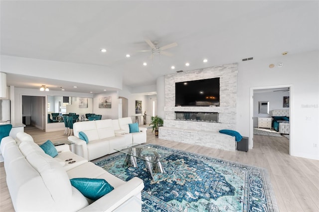 living room with visible vents, recessed lighting, light wood finished floors, ceiling fan, and vaulted ceiling