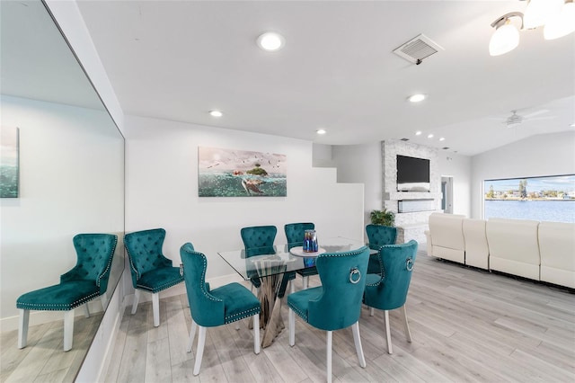 dining room with visible vents, wood finished floors, recessed lighting, baseboards, and vaulted ceiling