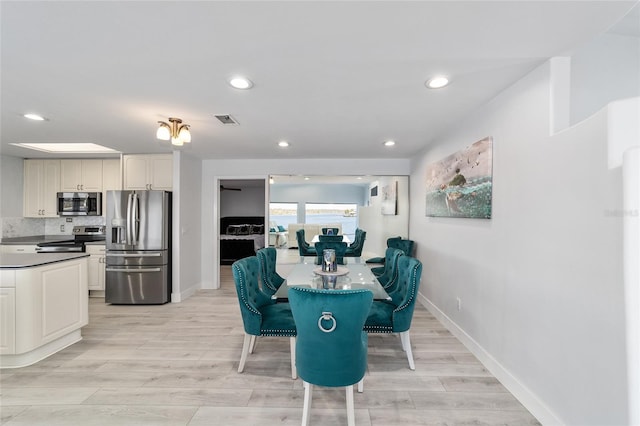 dining room with recessed lighting, visible vents, baseboards, and light wood-style floors