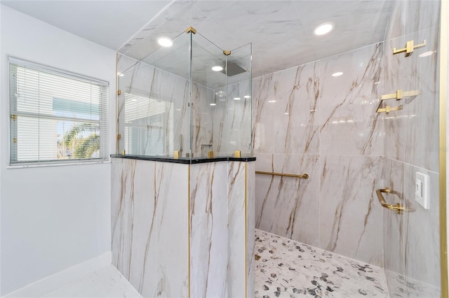 bathroom with a marble finish shower and recessed lighting