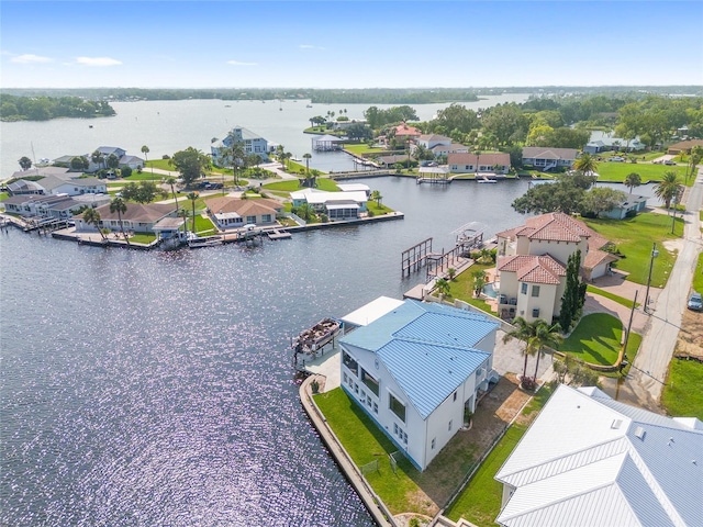 drone / aerial view with a residential view and a water view