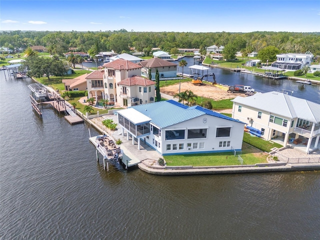 drone / aerial view featuring a residential view and a water view