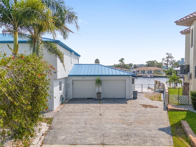 garage featuring fence and driveway