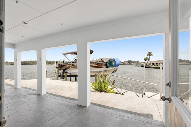 view of patio / terrace featuring a water view, boat lift, and a dock