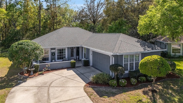 ranch-style house with cooling unit, driveway, roof with shingles, stucco siding, and a garage