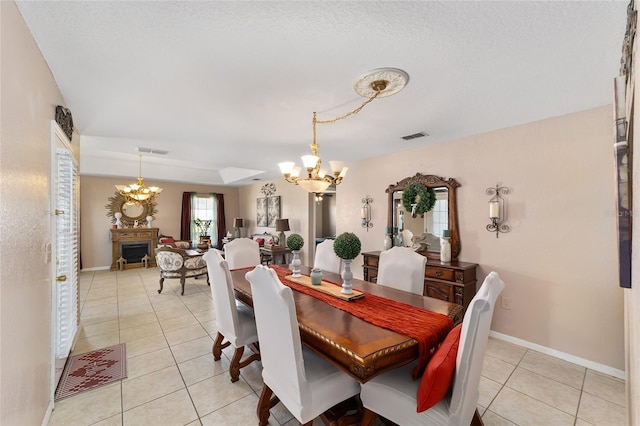 dining room with visible vents, baseboards, a notable chandelier, and light tile patterned flooring