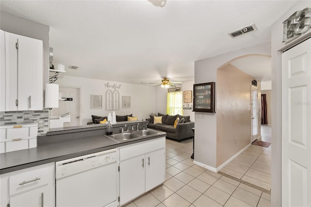 kitchen featuring light tile patterned floors, visible vents, white dishwasher, a sink, and open floor plan